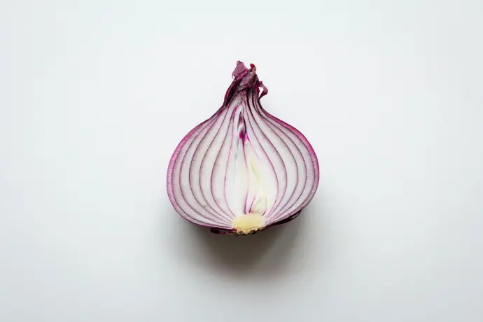 pink and white garlic on white surface